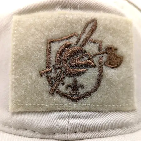 Photo of a logo embroidered onto a hook and loop rectangular patch