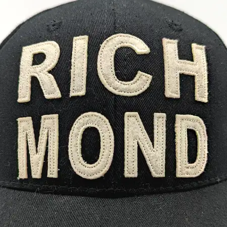 Photo of felt patches cut in the shape of individual letters to form the word RIGHMOND