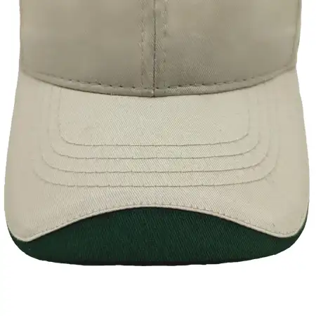 Photo of fabric applique on the upper visor of a cap, with the fabric covering just the front edge of the visor, whih arches up towards the center of the visor